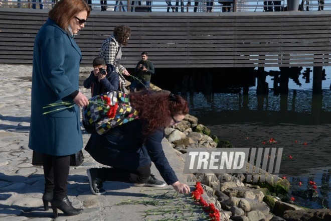 Baku residents bringing flowers to Seaside Boulevard to honor missing oil workers.  Azerbaijan, Dec.07, 2015